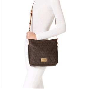 Michael Kors PVC jet set cross body bag with brown leather shoulder strap.